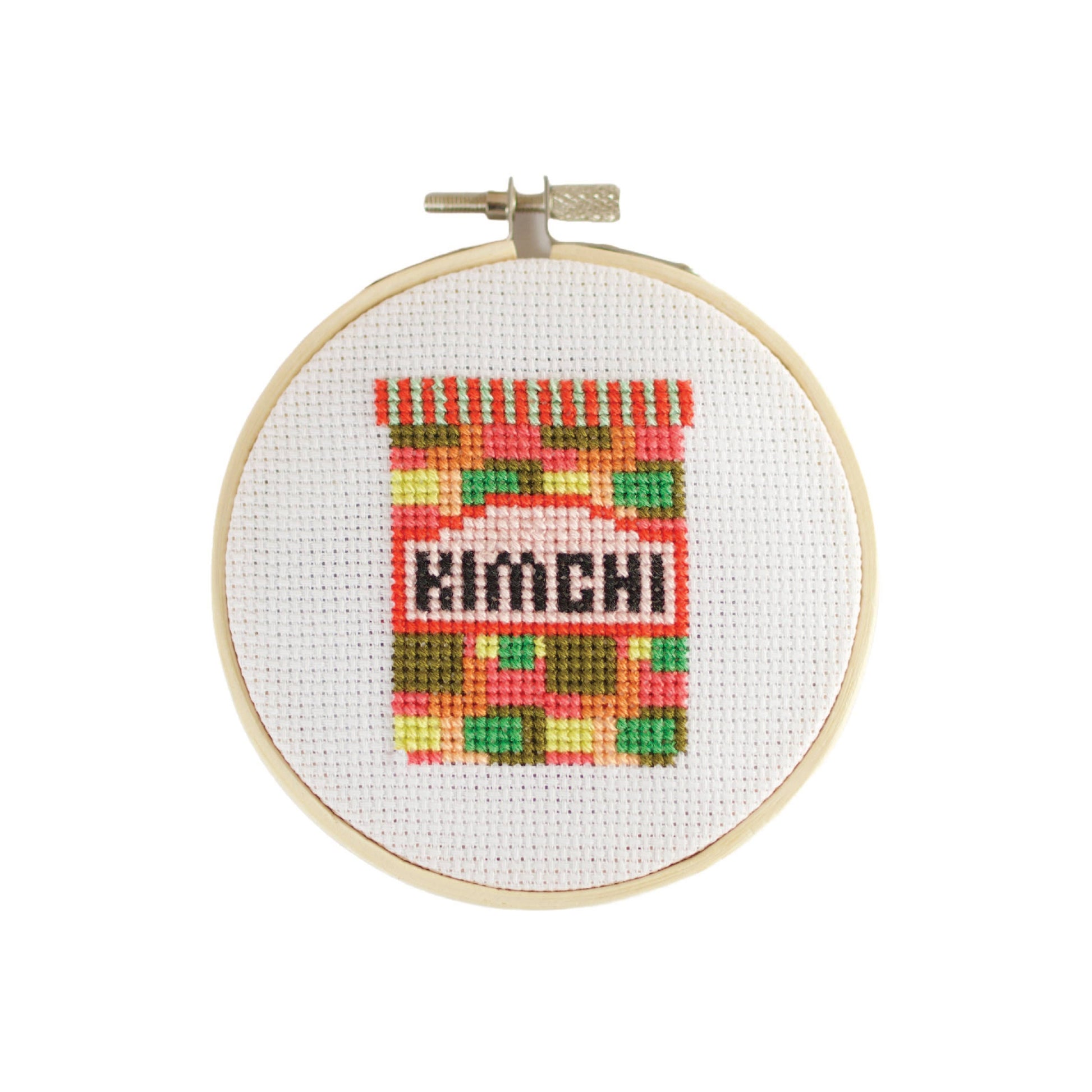 Side view of the Kimchi Mini Cross Stitch Kit's plastic-free, recyclable striped box with branding visible.
