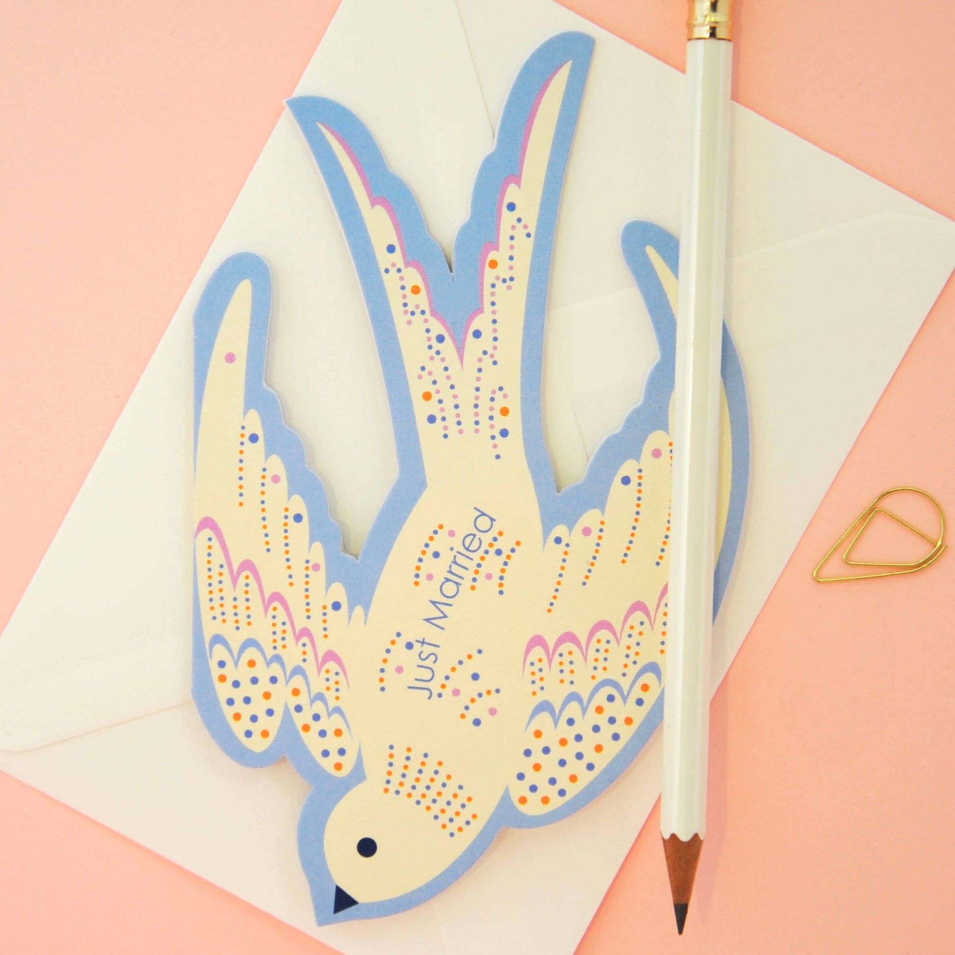 Rocking bird wedding card displayed on a mantelpiece