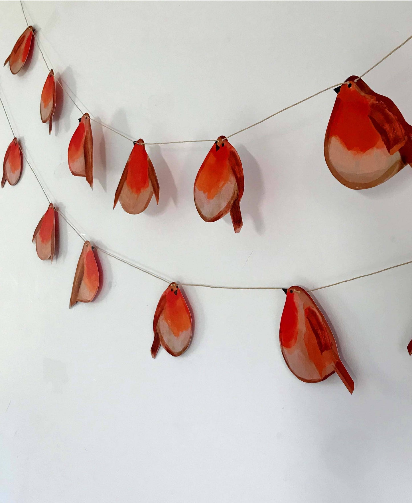 Festive Robin Garland by Wini Tapp featuring 12 double-sided printed robins, 2 metres long, printed on cardstock, strung on hemp string
