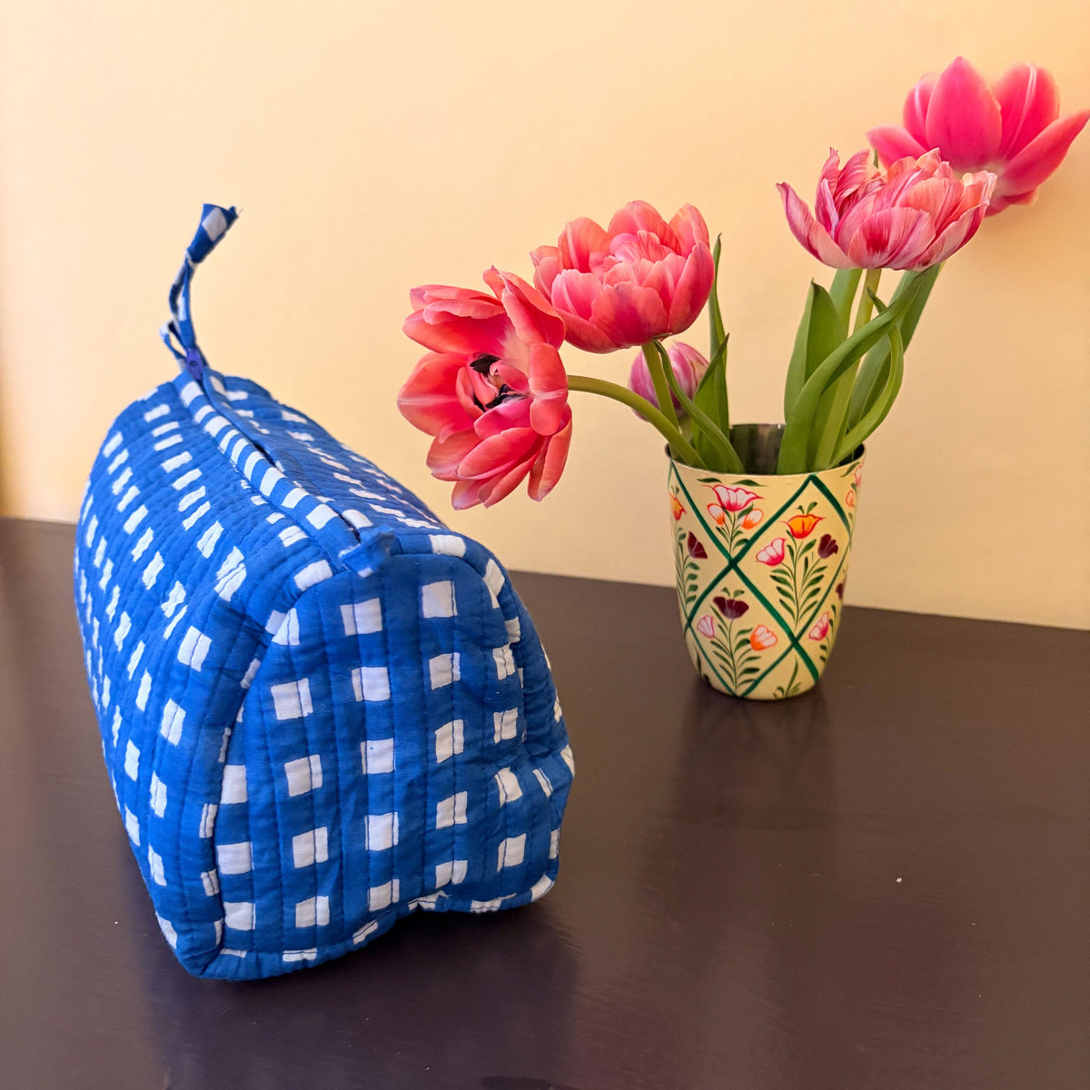 Inside of cobalt check cosmetic bag showing waterproof lining and pockets