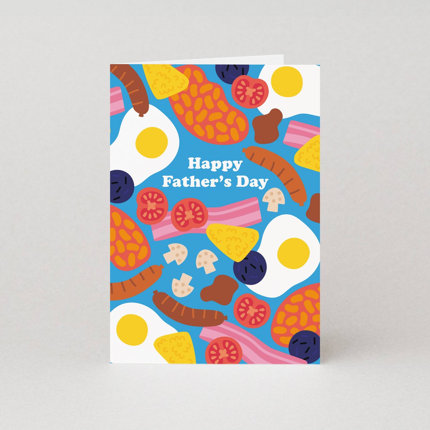 Beans. Bacon. Eggs. Mushrooms. Sausages. Hash Browns. Black Pudding. This Father's Day card is serving up a Full English Breakfast, a favourite for countless dads. The delicious illustrated breakfast foods are scattered across the bright blue background of the Father's Day greeting card with its simple "Happy Father's Day" caption standing out in the middle. The inside of the greeting card is blank for a personal message to be added