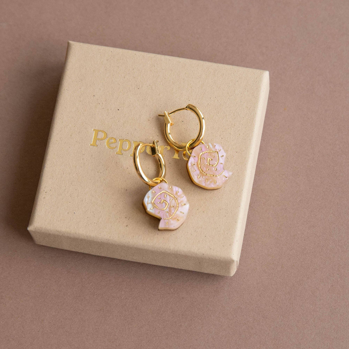 Removable shell charms on gold hoop earrings