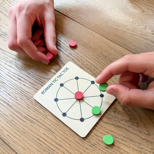 Close-up of Cotton Twist Roman Tic Tac Toe wooden board game with coloured tokens ready to play
