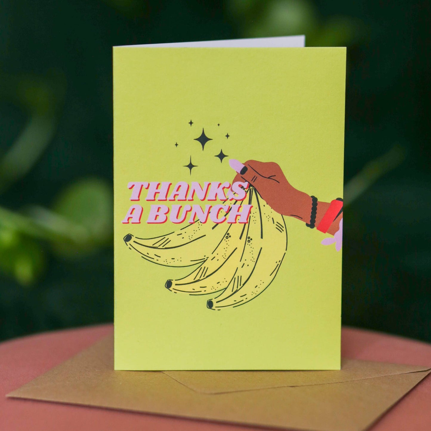 Vibrant yellow A6 thank you card featuring a bunch of bananas and a diverse Black character