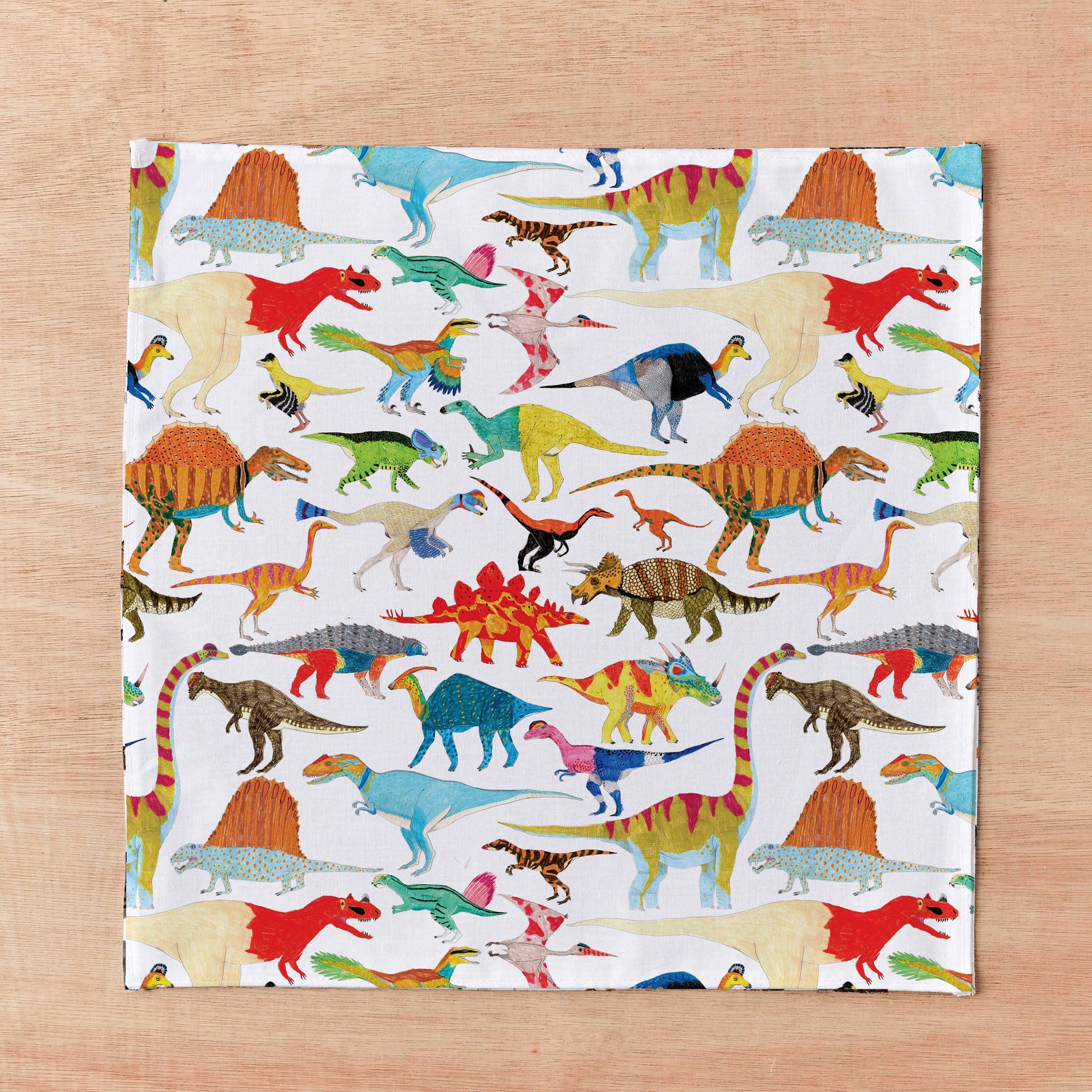 Roar into style with this playful handkerchief pocket square showcasing more than 20 illustrated dinos and prehistoric pals in a repeating pattern! Works double-duty as a dapper pocket square or practical hanky! The perfect cheeky gift or stocking surprise for fashion-forward folks who aren't afraid to show their wild side!
