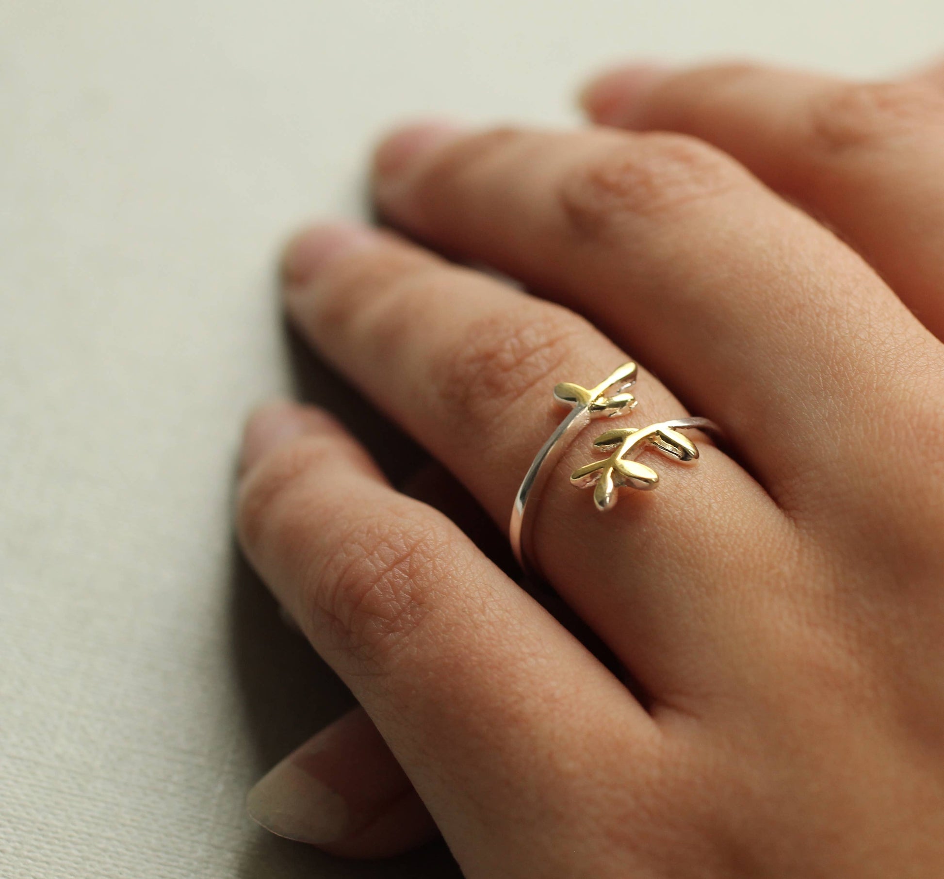 This sweet and delicate botanical inspired ring is made from Sterling silver, with touches of gold plating on the tips. The ring has an open, or adjustable form which can fit most fingers.