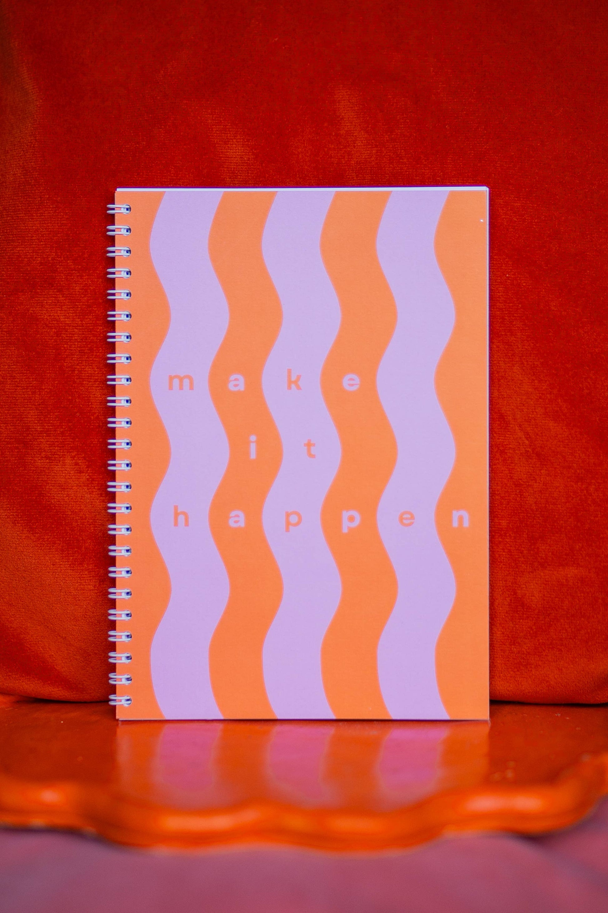 A5 wiro-bound notebook with vibrant pink and orange stripes