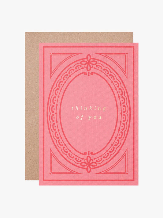 Thinking of You eco-friendly greeting card with hot foil text on pink buckram-textured card, inspired by a vintage book cover, with a recycled kraft envelope.