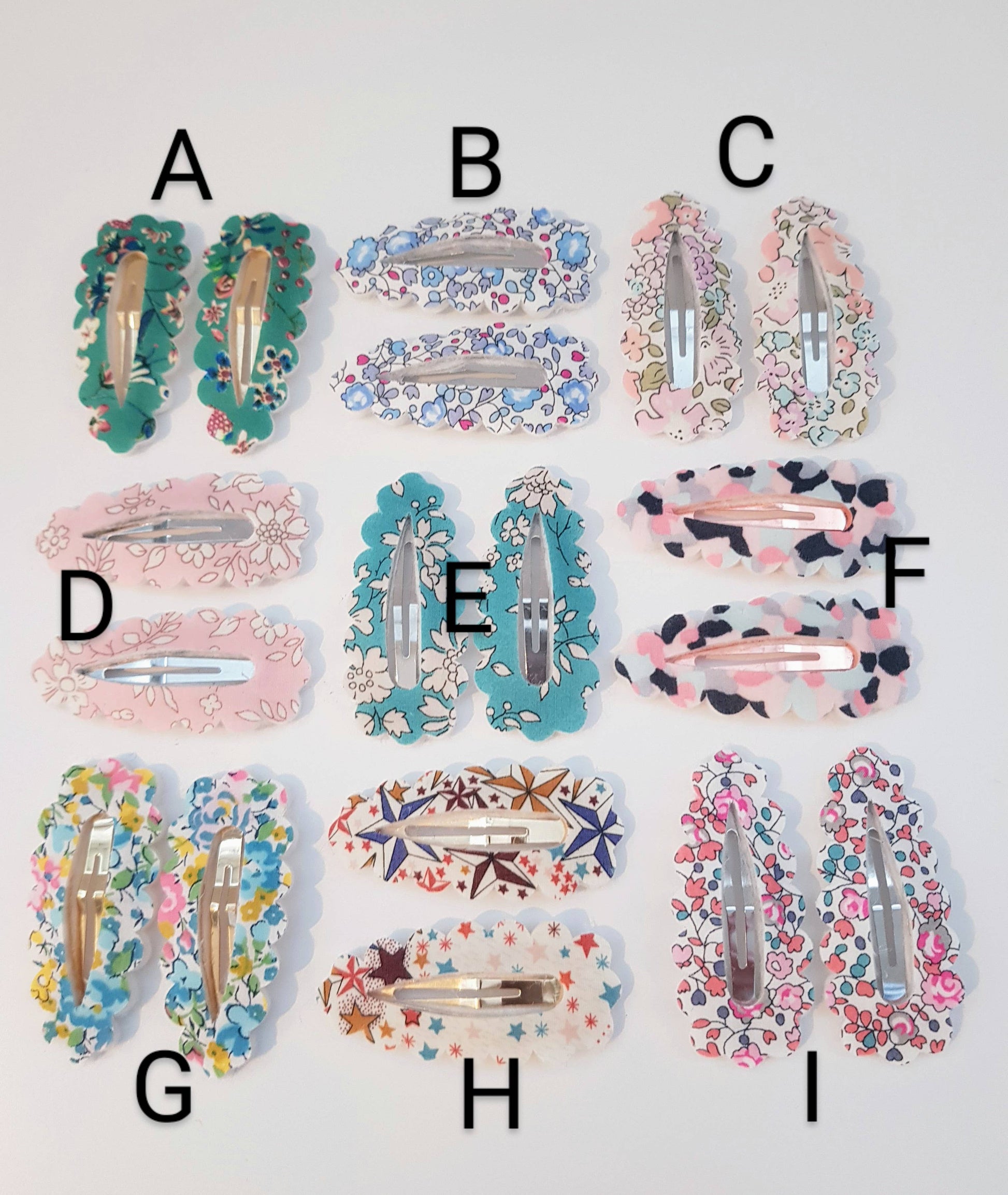 Collection of colorful hair clips labeled A to I on a white background