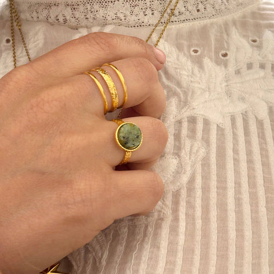 Close-up of the 18k gold-plated triple band ring showing delicate hammered detail