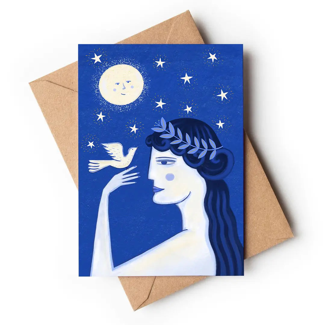 Greeting card with a woman's face, dove, and moon illustration on a blue background with a brown envelope.