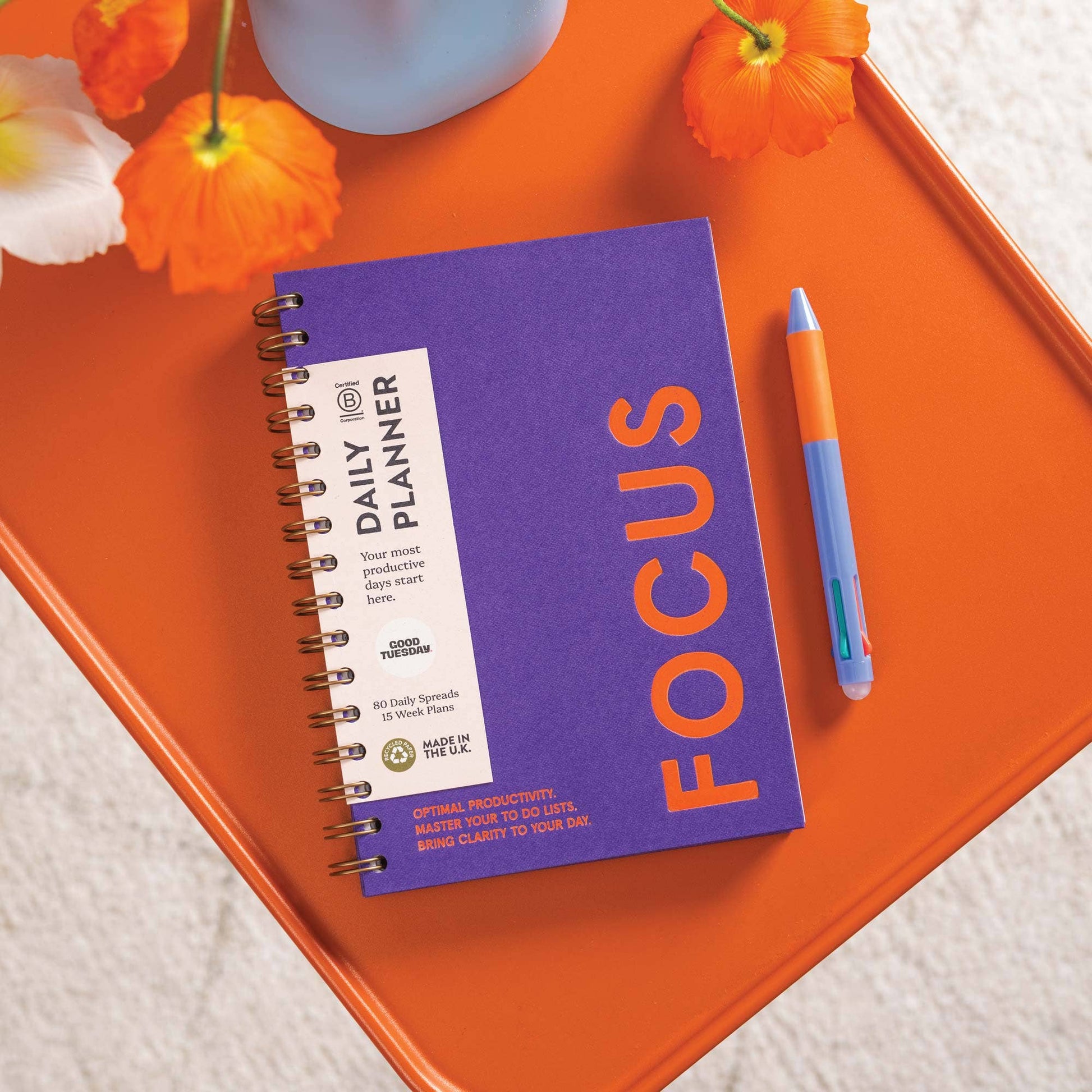 Purple undated daily productivity planner with bold orange typography