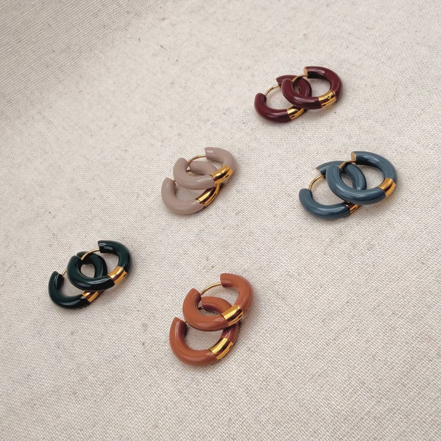 Various colours of Little Nell Tonal Enamel Hoops on display