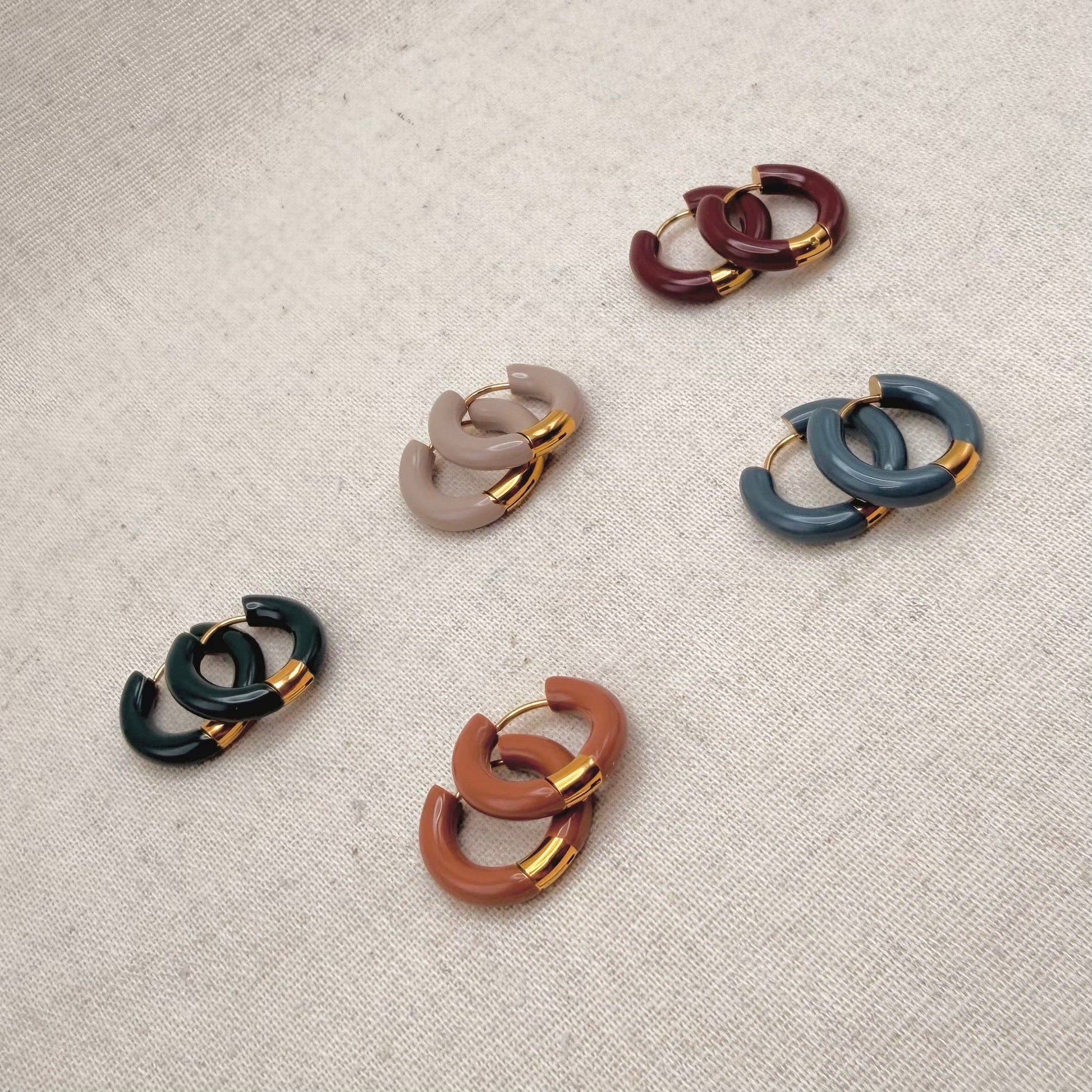 Various colours of Little Nell Tonal Enamel Hoops on display