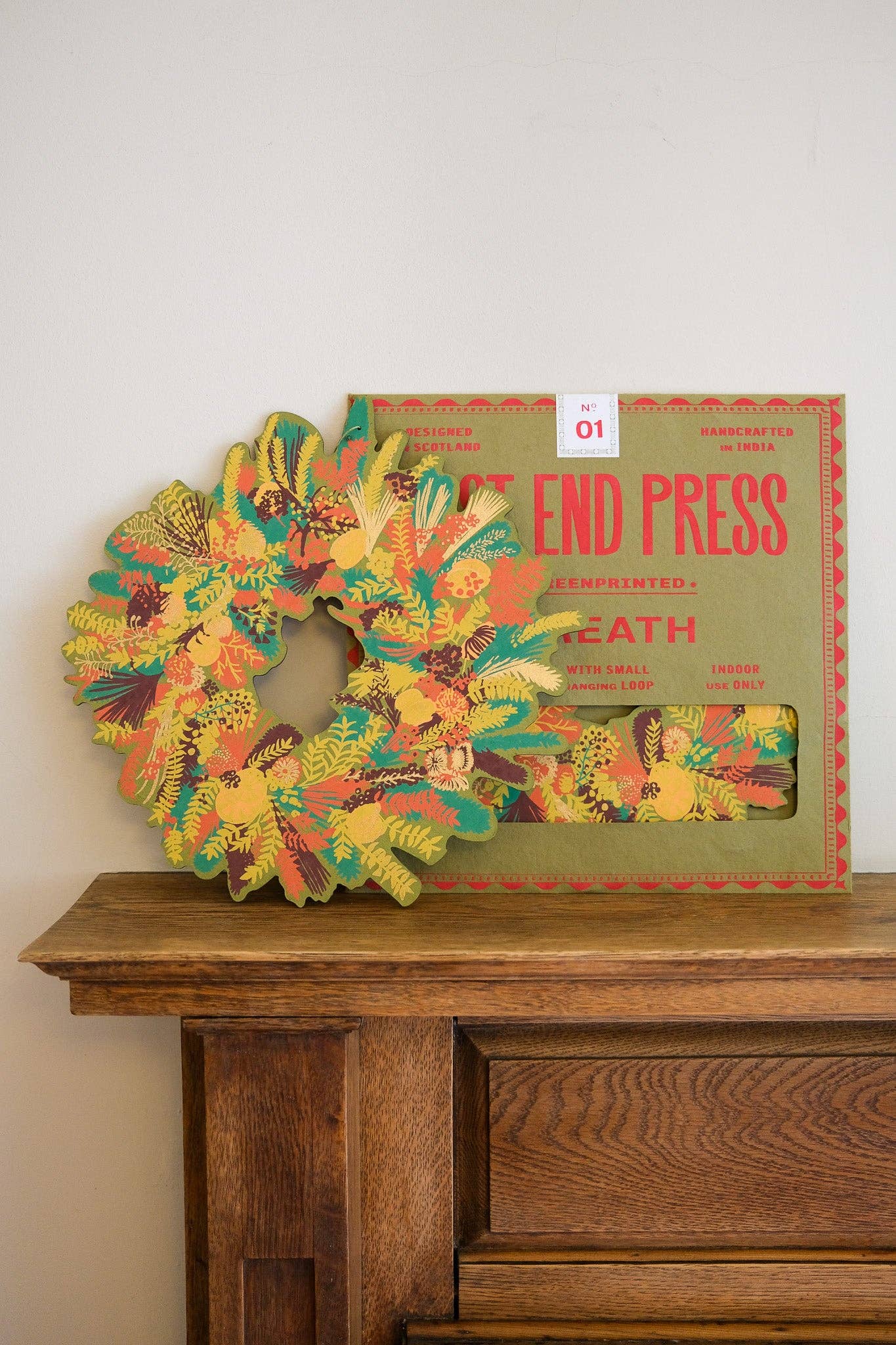Hand-printed cotton board wreath with winter blooms, sustainable Christmas ornament