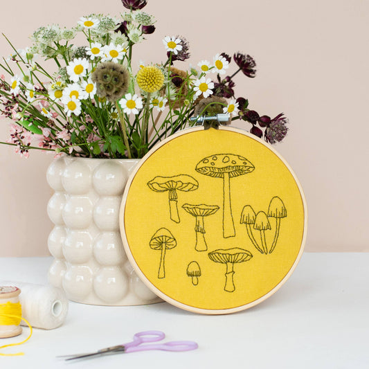 Yellow Fungi Embroidery Hoop Kit by Cotton Clara, featuring seven different fungi designs to embroider