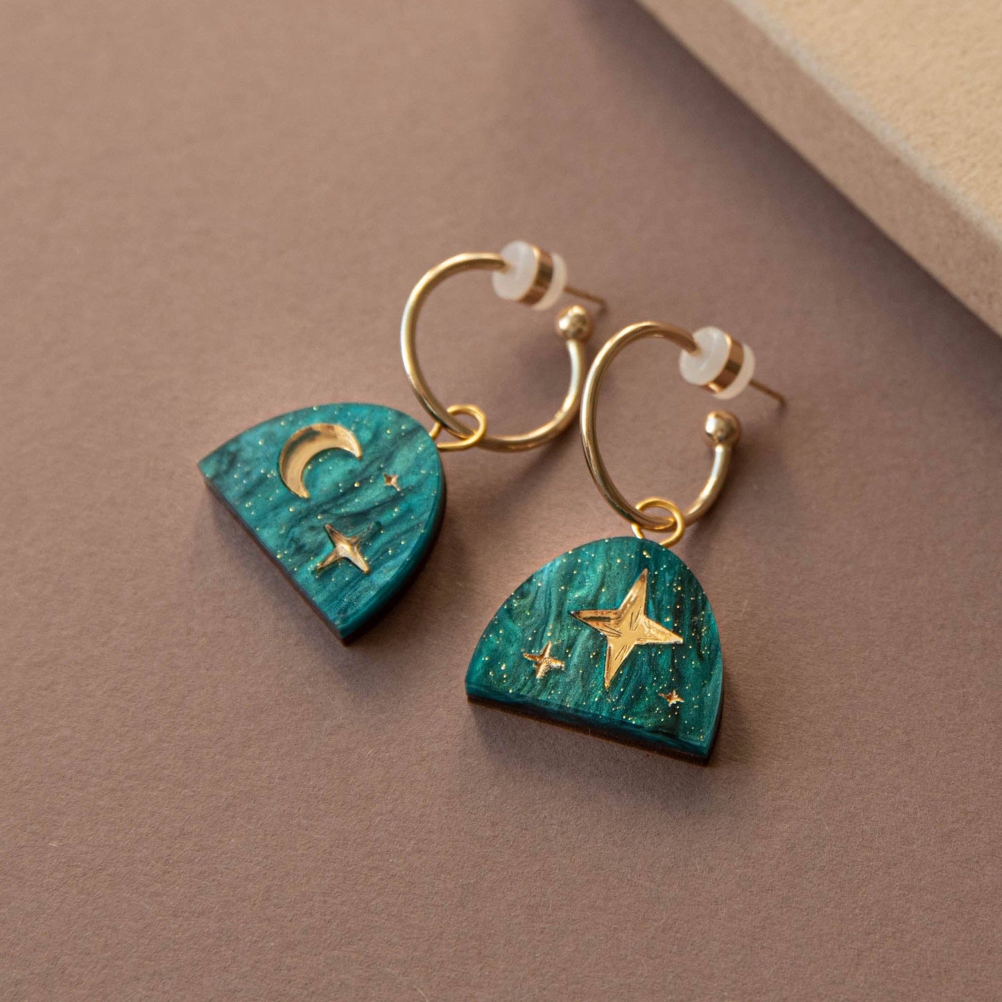 Close-up of Teal Marble & Gold Moon Rising Arc Hoop Earrings, featuring sustainable wood and 20mm gold-plated brass hoops.