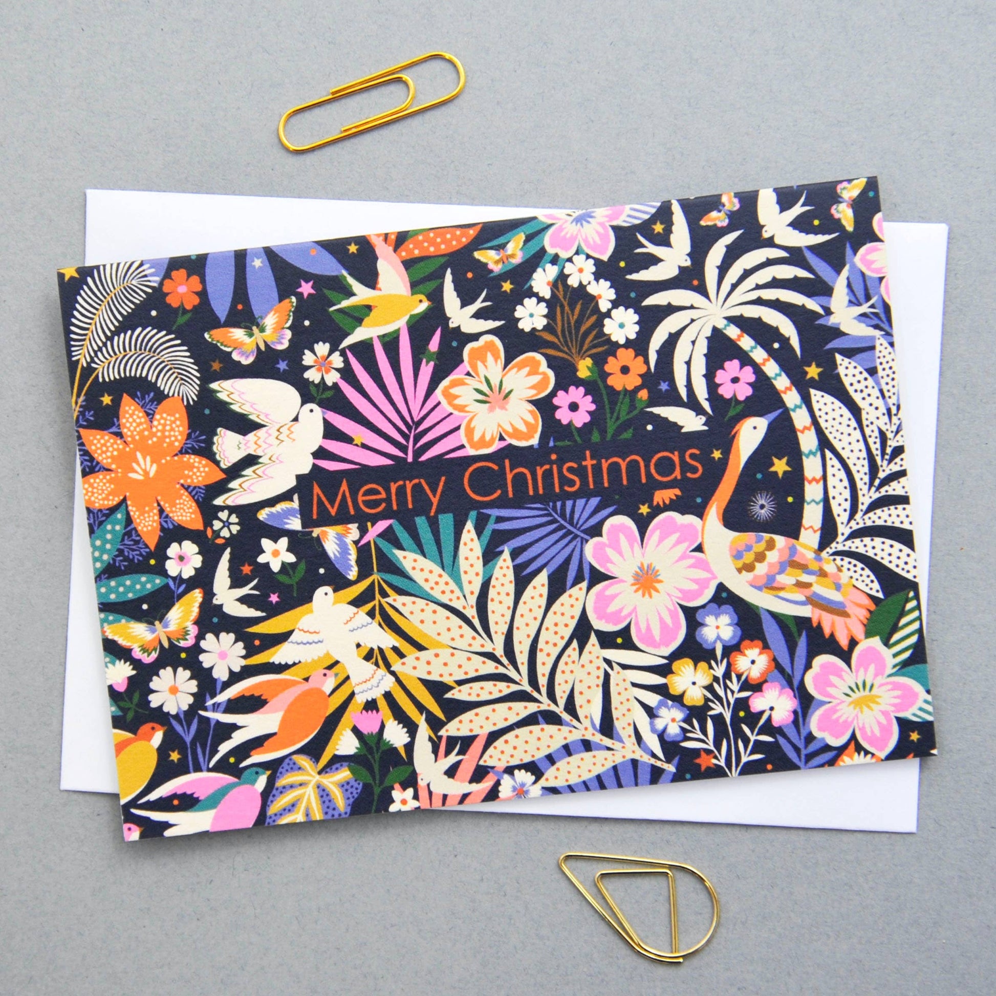 Christmas notecard with vibrant flora and fauna illustration on a dark background, 'Merry Christmas' text.