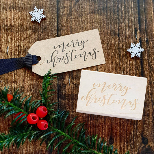 Handmade Merry Christmas calligraphy rubber stamp on eco-friendly wooden block, perfect for sustainable Christmas crafts, made in Devon UK.