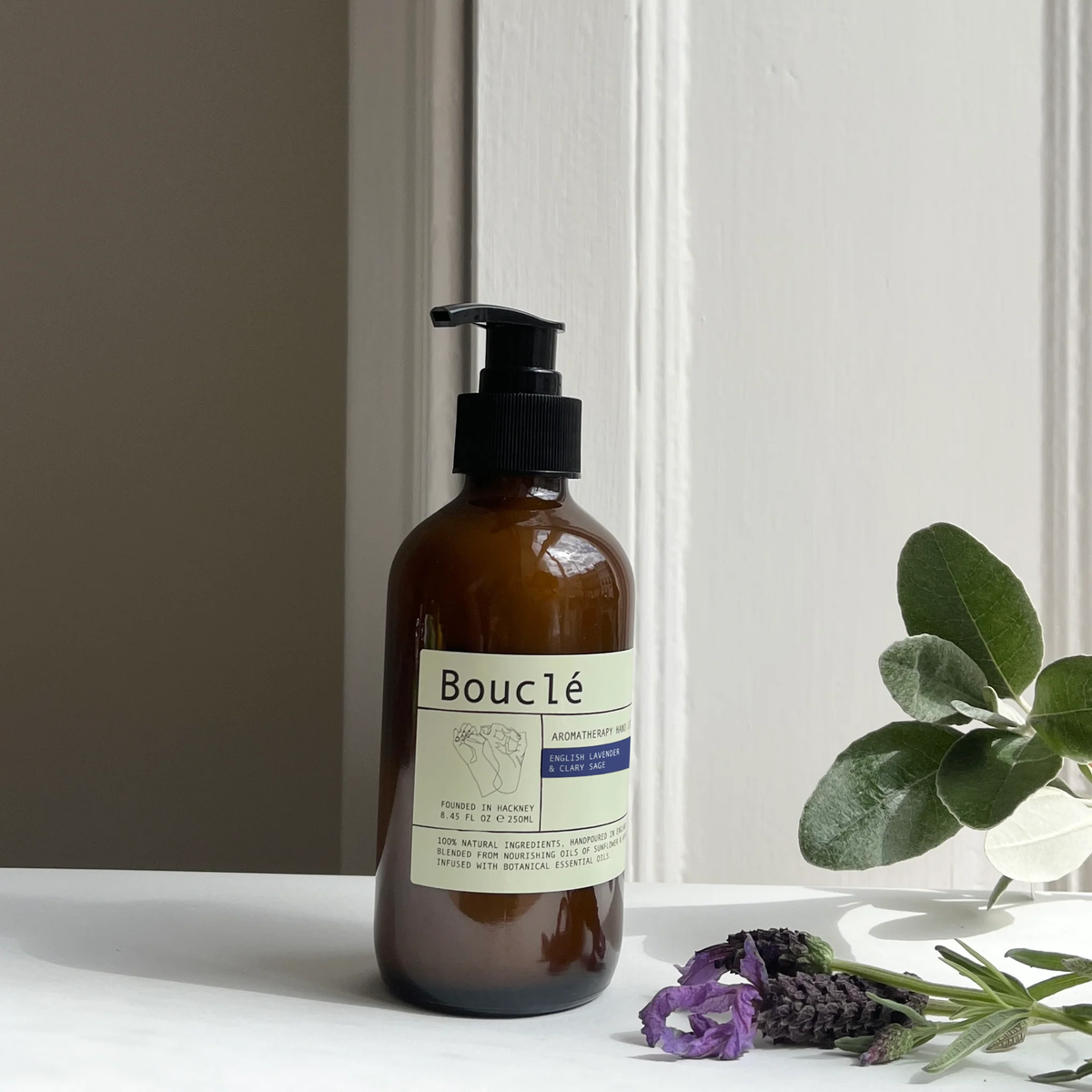 English Lavender and Clary Sage Essential Oil Hand Lotion in an amber glass apothecary bottle