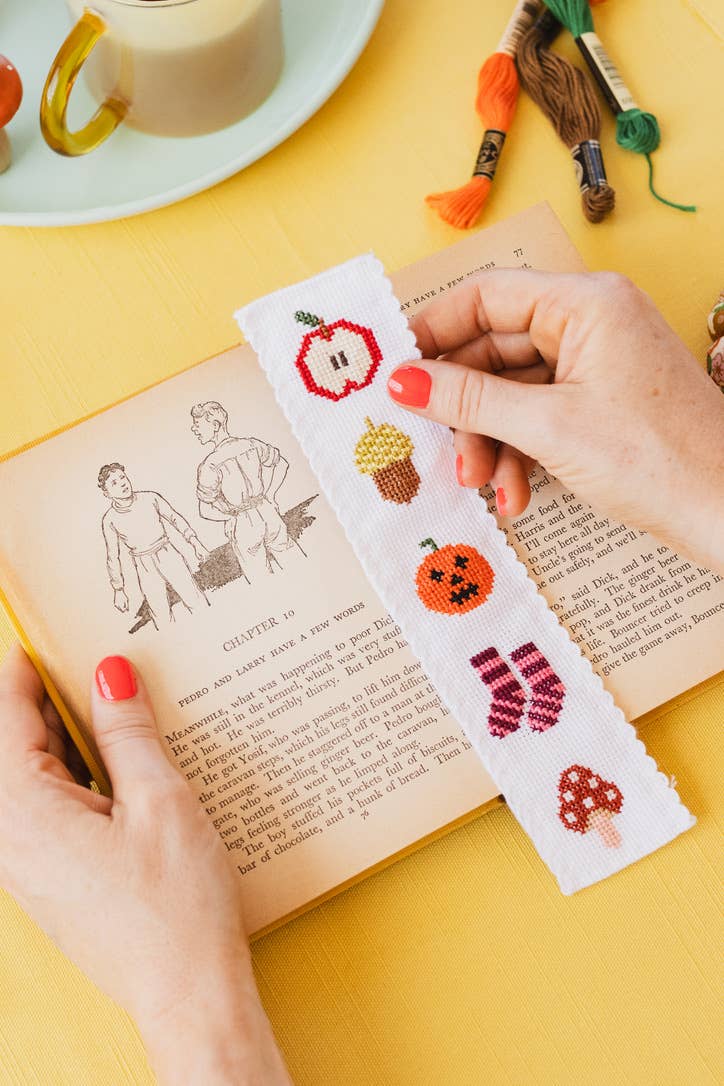 Completed autumn themed cross stitch bookmark with pumpkin and acorn design
