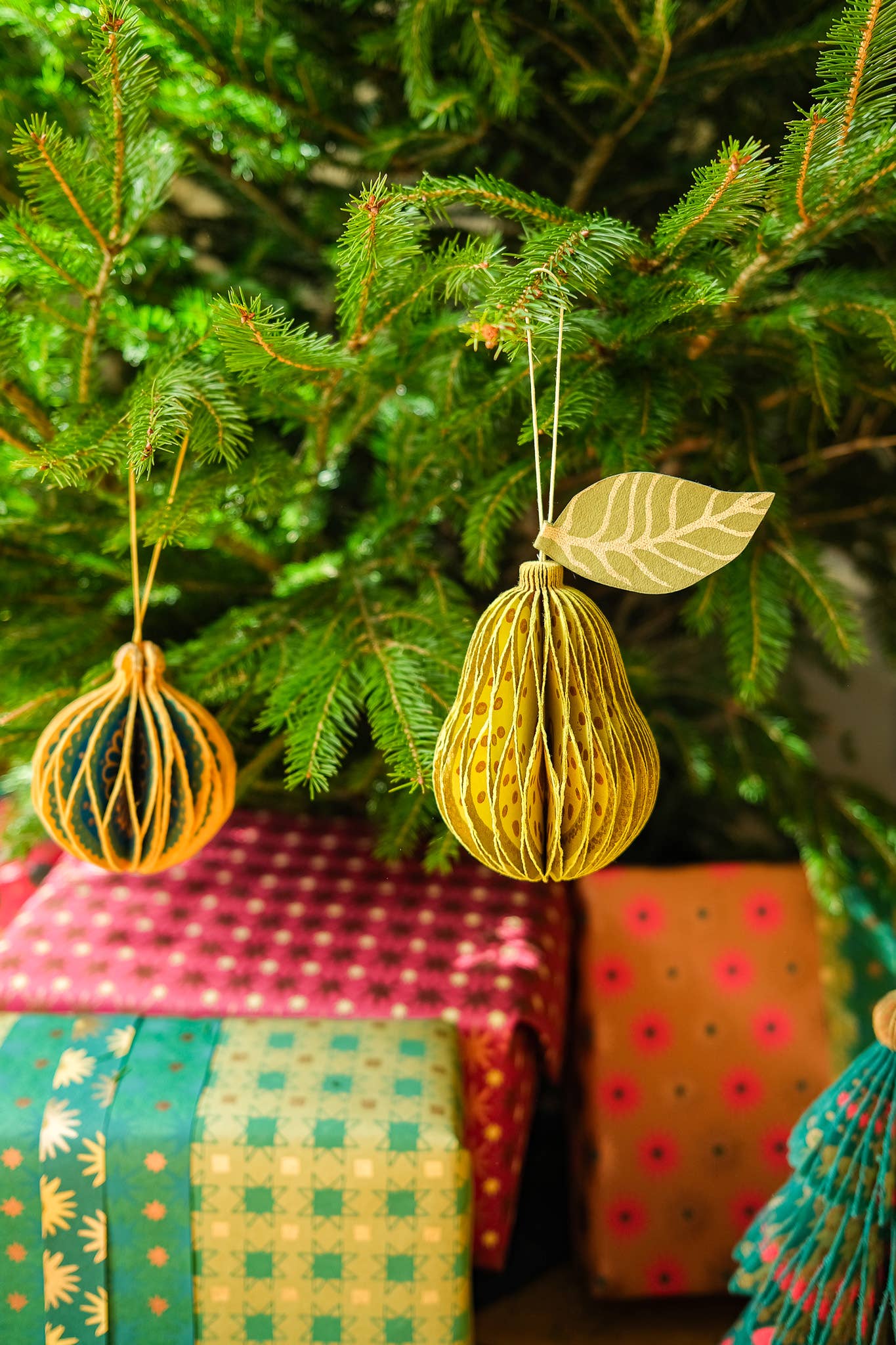 Front view of an unfolded recycled paper pear honeycomb ornament