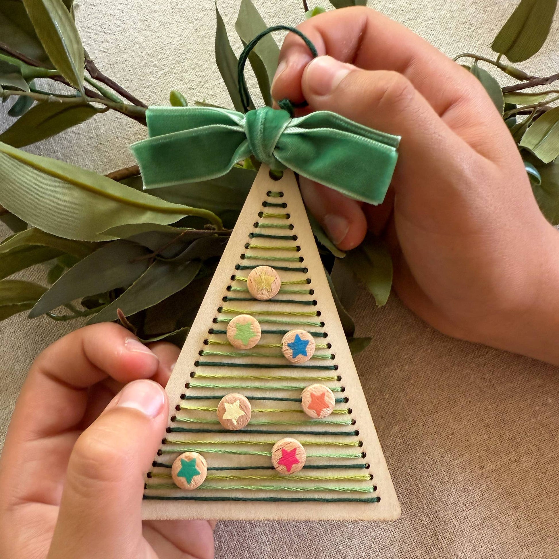 Cotton Twist stitched Christmas tree decoration kit with sustainably certified wooden tree base and cotton thread