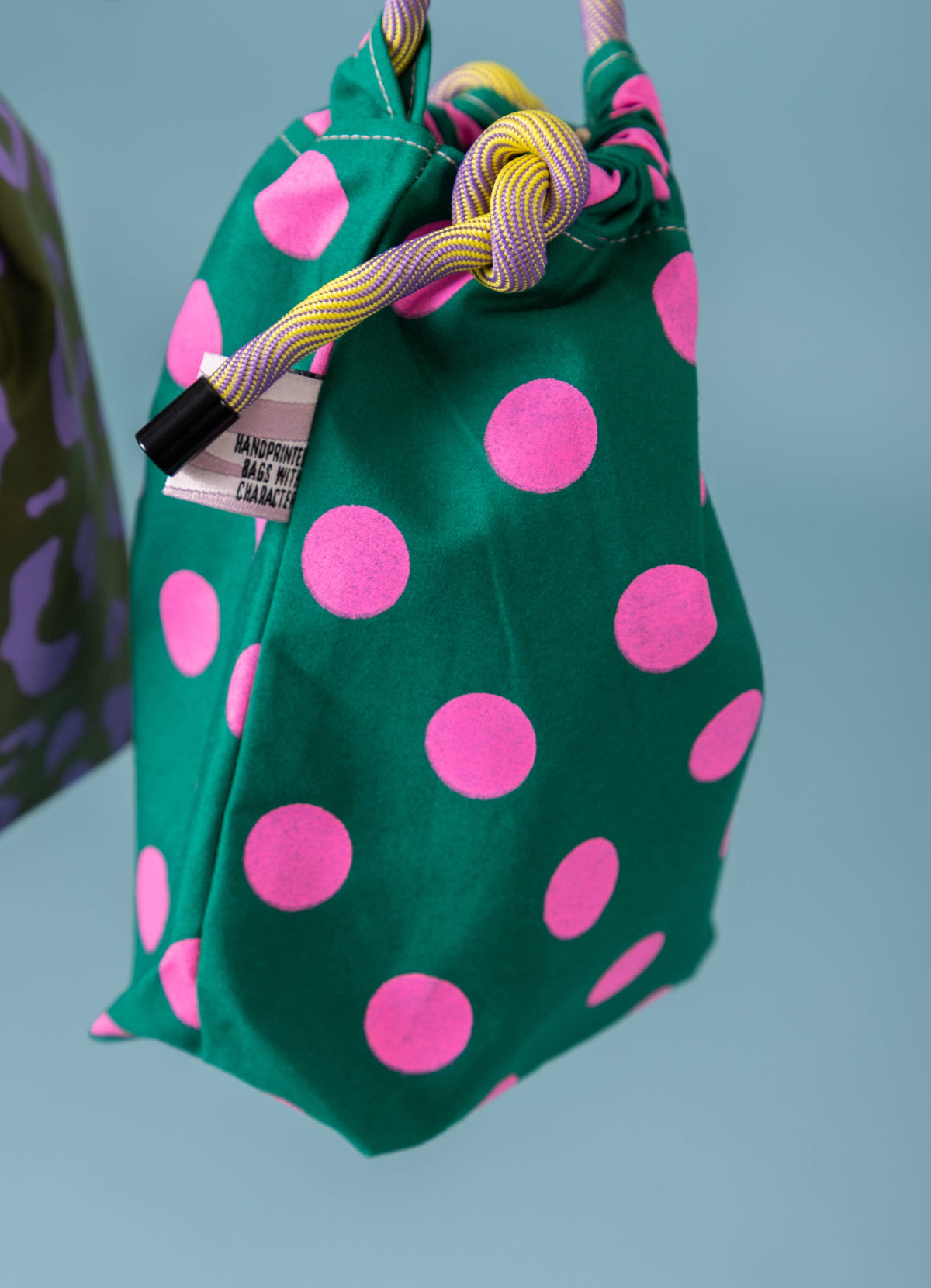 Compact drawstring bag showing surprise lining