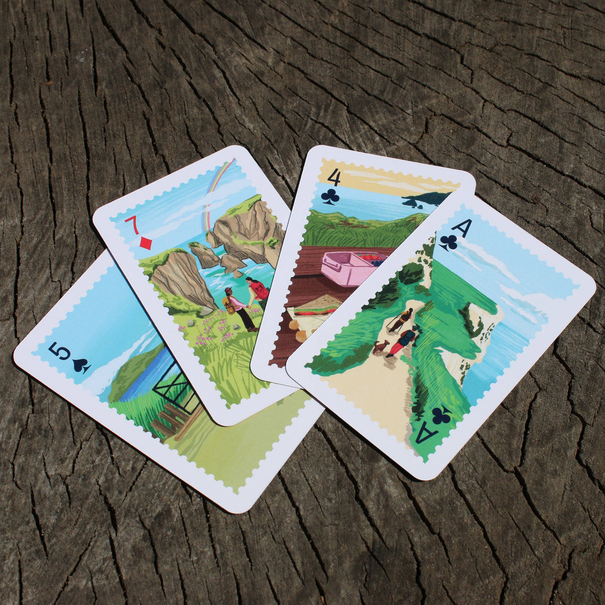 Close up of illustrated playing cards with UK mountain scenes