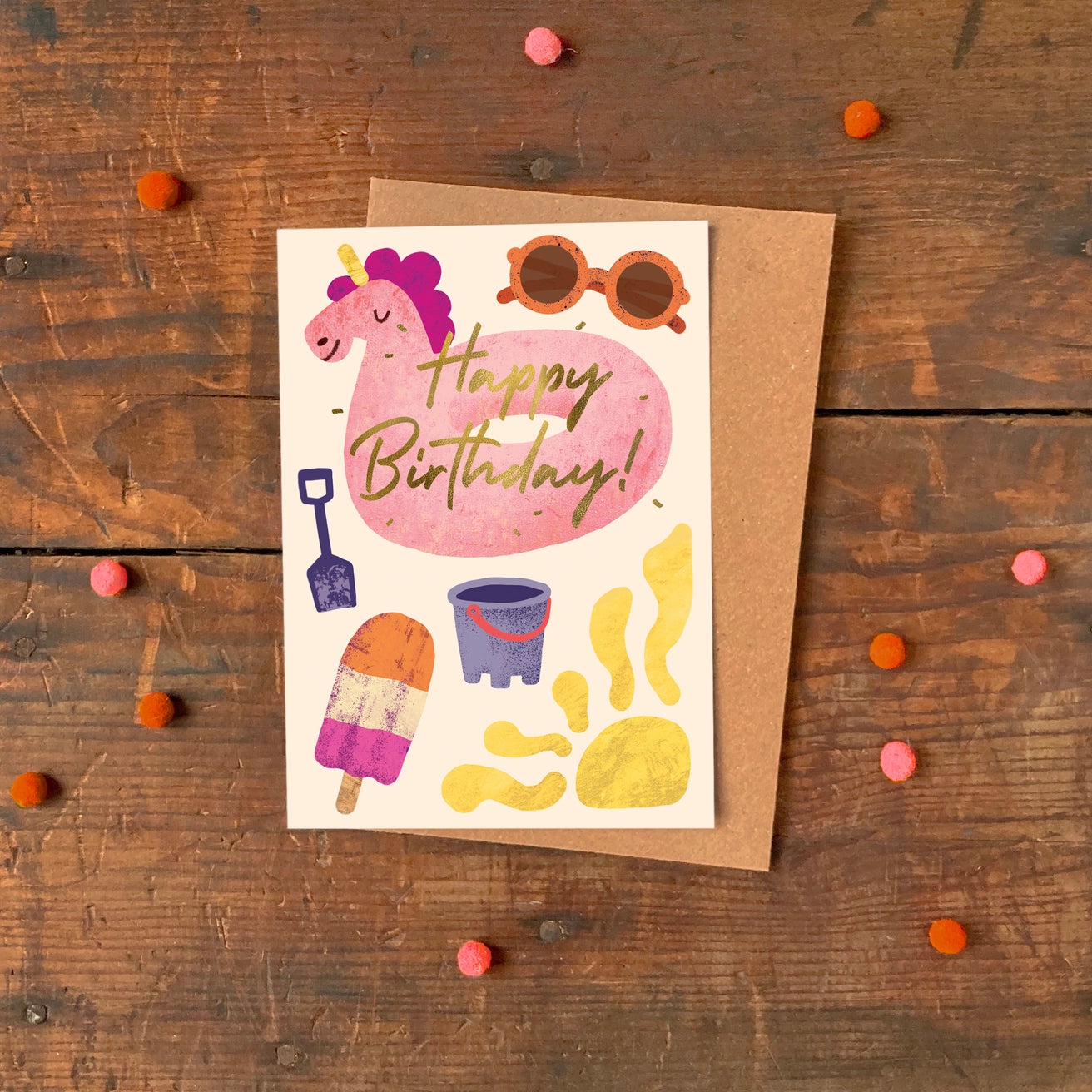Kids birthday card with a pink unicorn inflatable, sunglasses, and beach-themed illustrations on a yellow background.