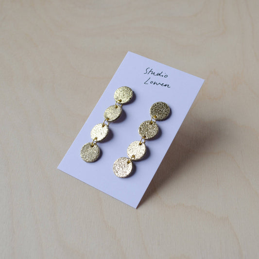 These Caja earrings are stunning and add a touch of sparkle and colour to any outfit, whilst also being very lightweight and comfortable to wear. Made from offcuts of our beautiful suedes and leathers, these have 4 mini circles of gold.

Gold plated Studs