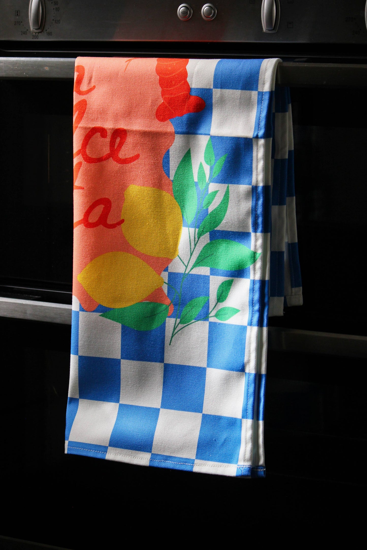 Full view of the checkered food-themed tea towel design