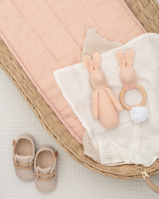 Rabbit teether for babies, featuring a plush cotton body and a natural beech wood ring, designed for tiny hands and teething relief.