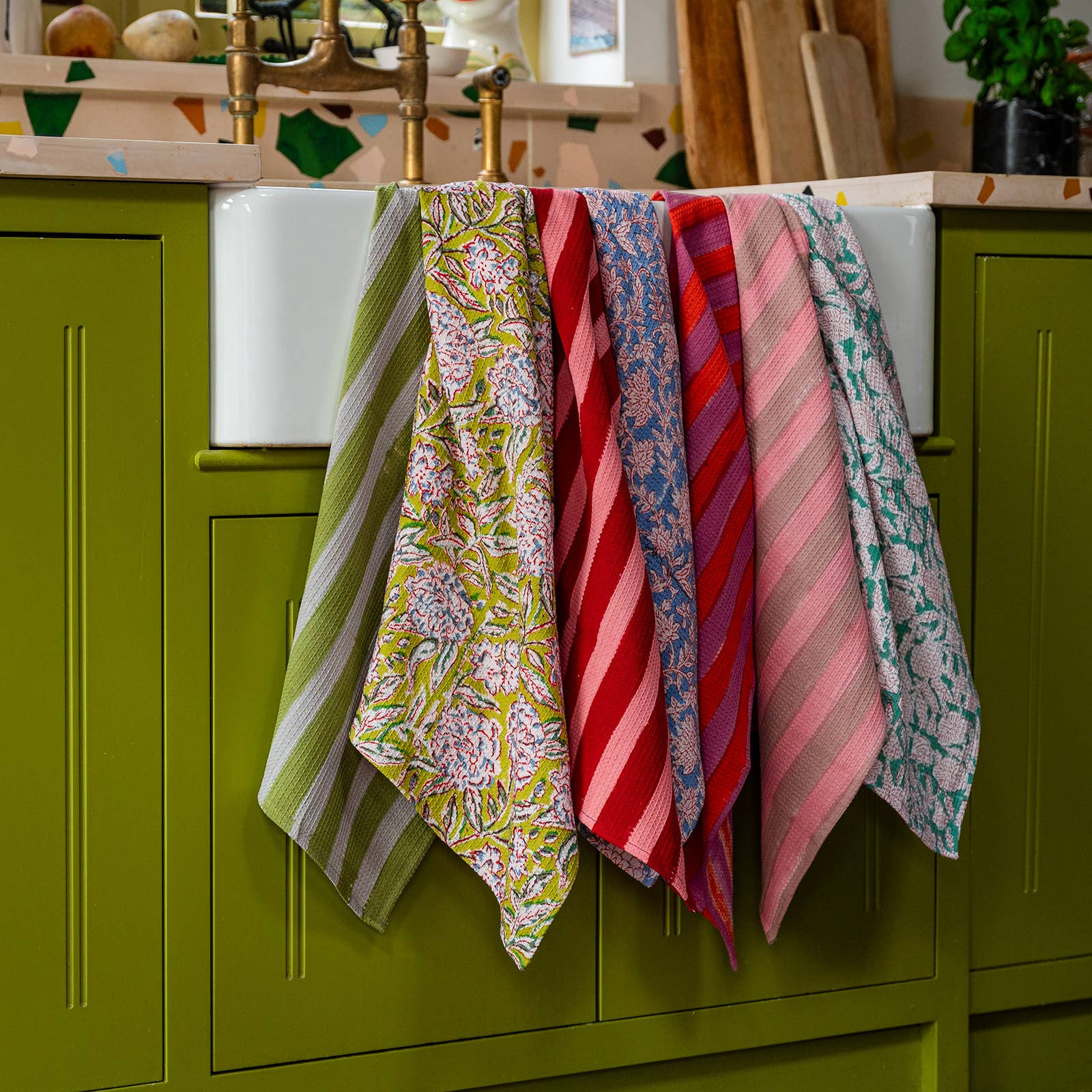 Evergreen tea towel hanging by its loop in a kitchen setting
