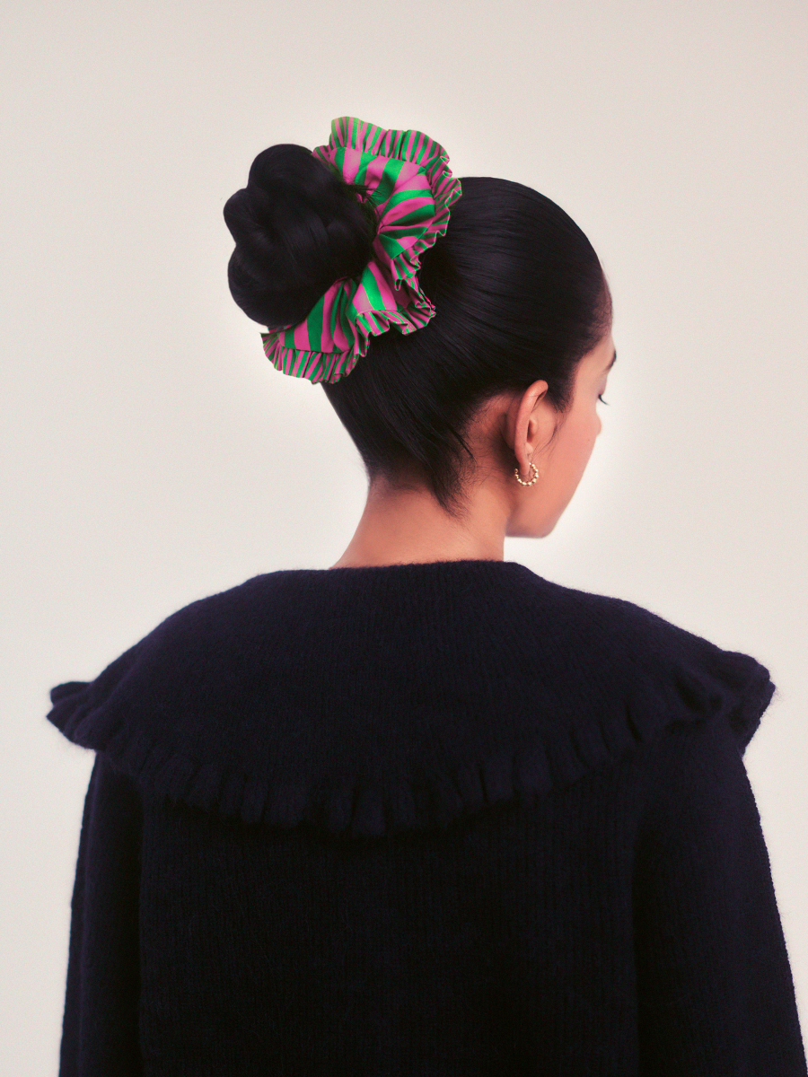 Close up of the frill detail on the green and pink stripe scrunchie
