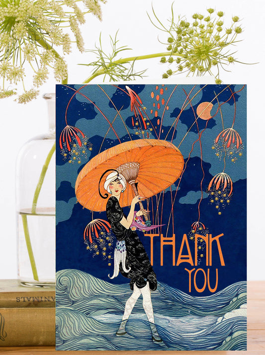 Hand glittered vintage thank you card showing a woman with orange umbrella on blue, encapsulated glitter, blank inside, 5x7”, with ivory envelope