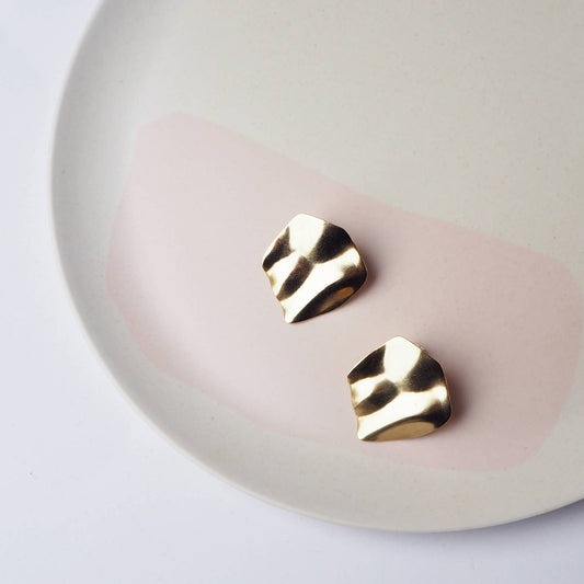 Purl wavy gold statement stud earrings on model