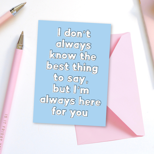 Blue card with text 'I don't always know the best thing to say, but I'm always here for you' on a white background with pink pens.