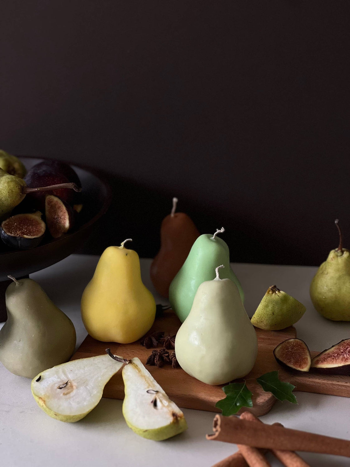 Scented pear candle on a decorative tray