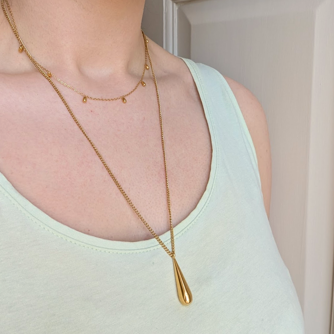 Hypoallergenic gold droplet necklace on display