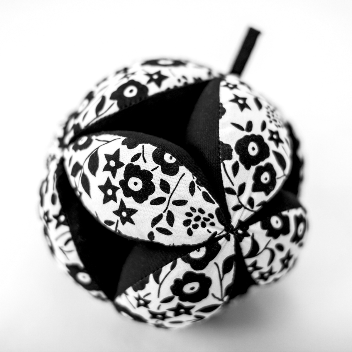 Etta Loves Liberty print baby sensory toy hanging on a pram