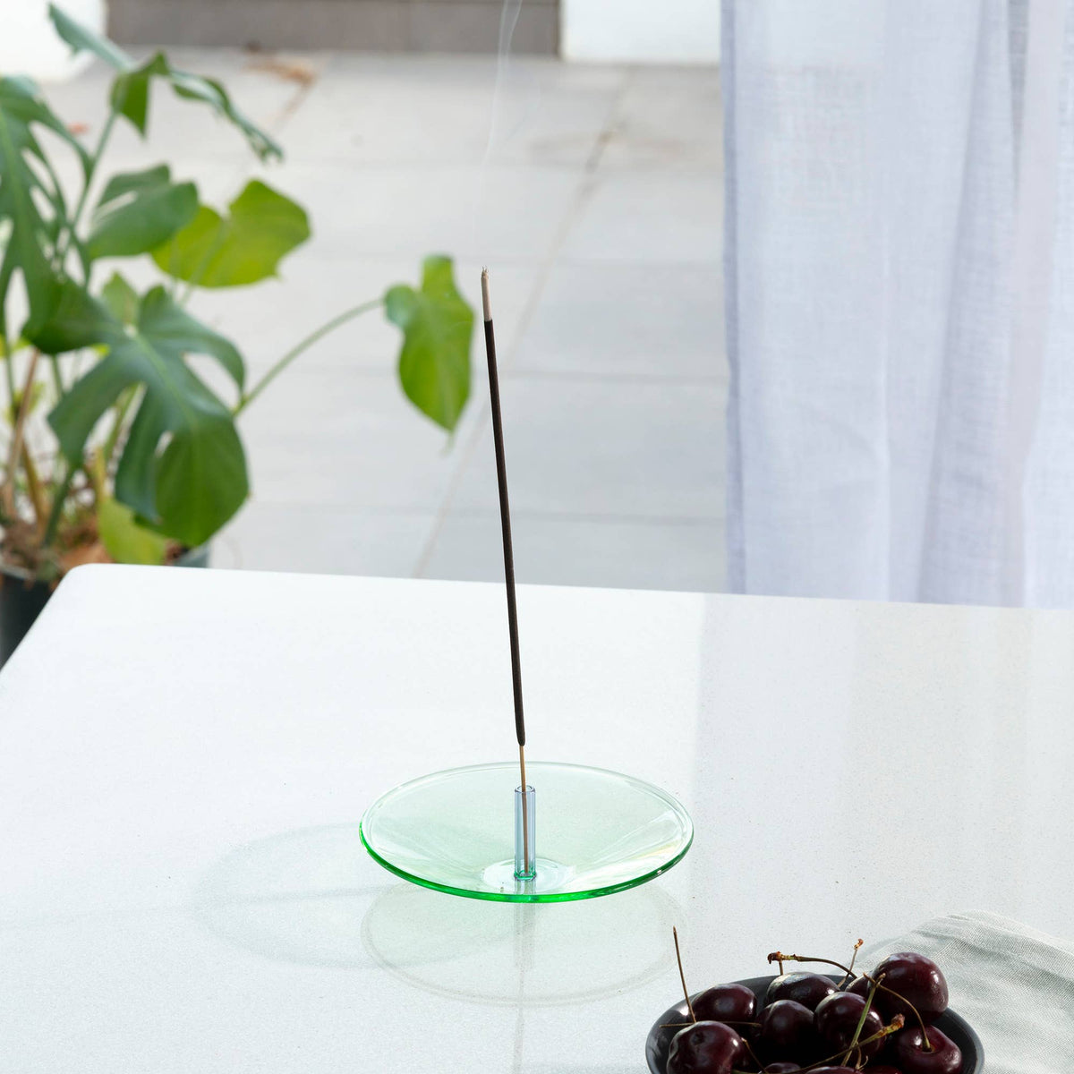 Float glass incense holder styled on wooden shelf