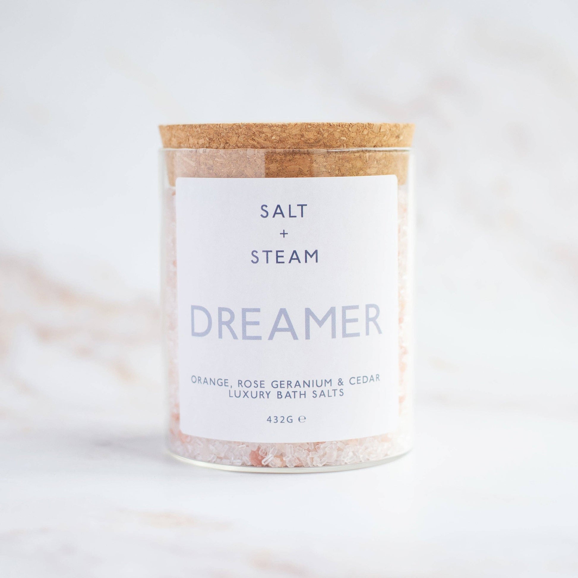 Floral and woody scented vegan bath salts in plastic-free packaging.