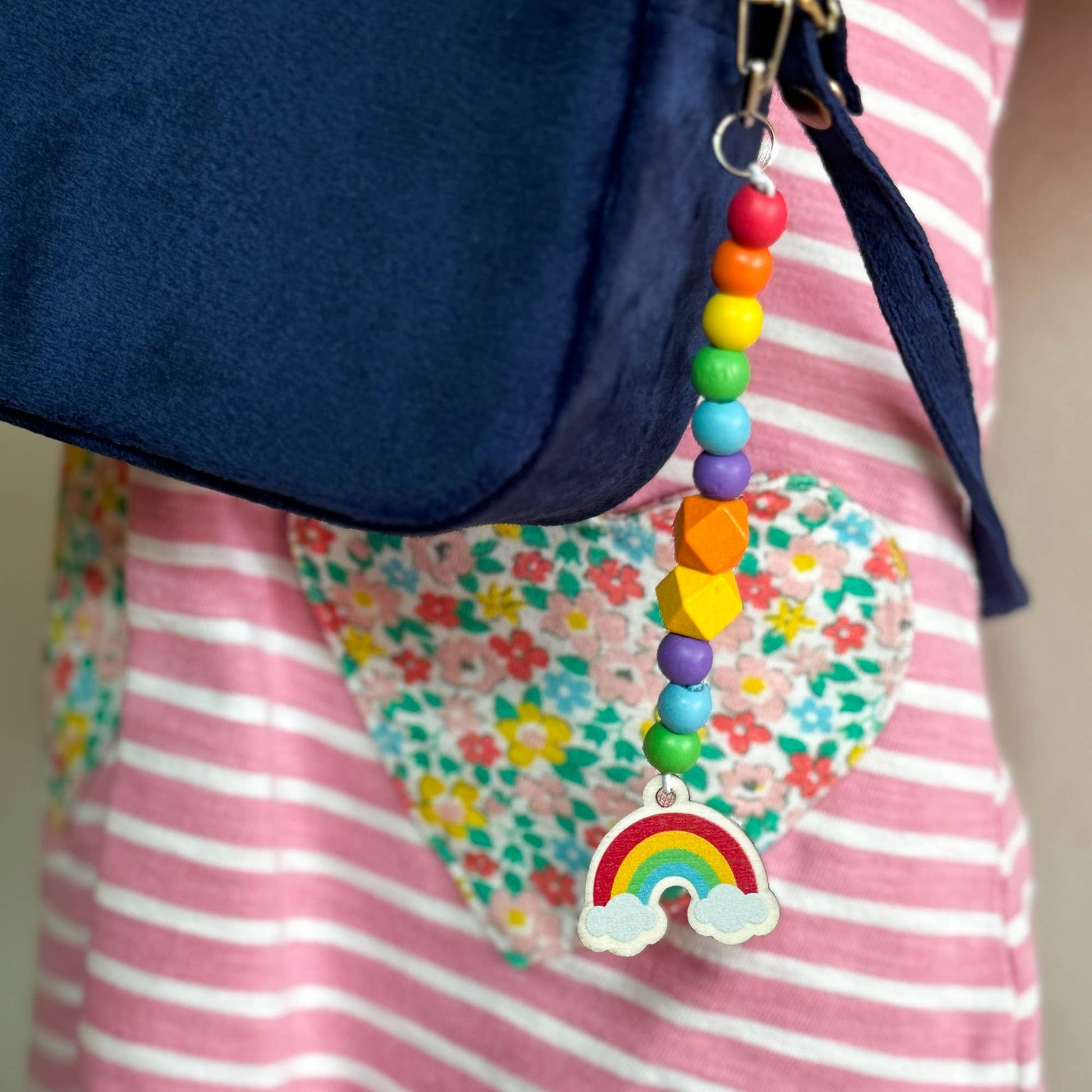 The Lucky Dip Keyring hanging from a kids rucksack