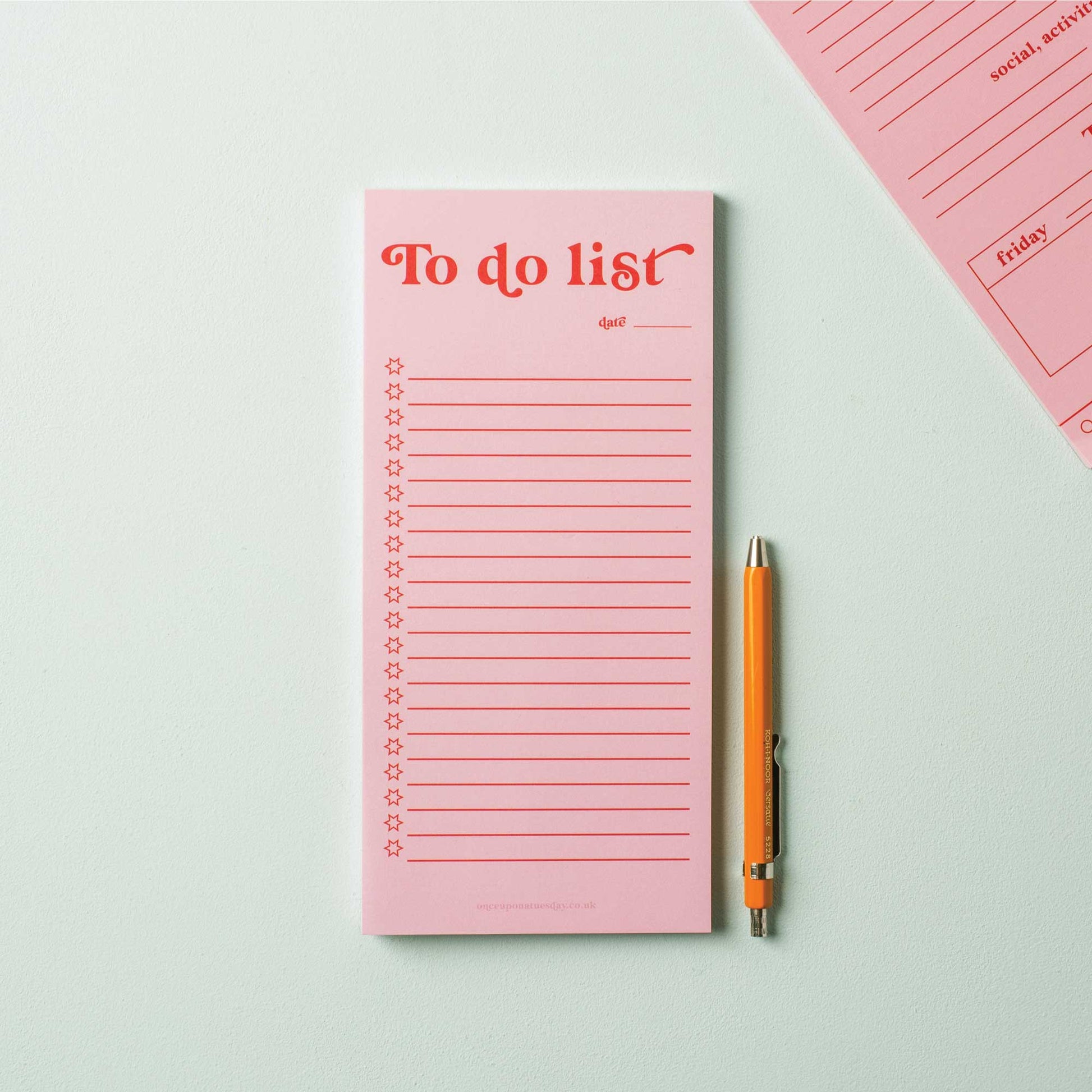 Pink and red to-do list pad on desk