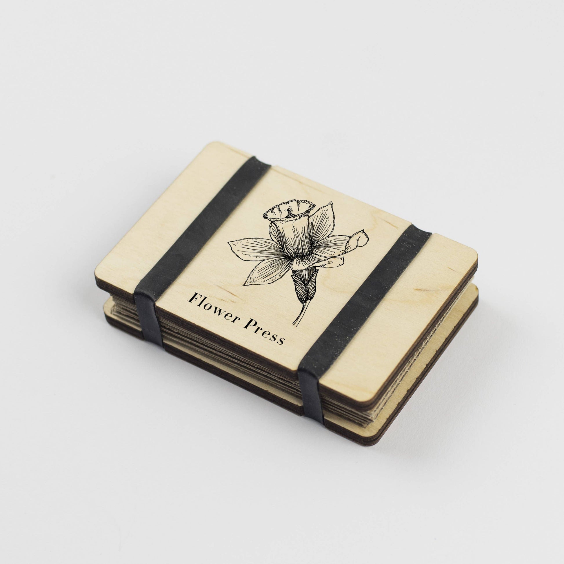 Pocket Flower Press made from sustainable maple veneered wood with corrugated card and sugar paper sheets, silicone rubber bands; pocket-sized and handmade in England.
