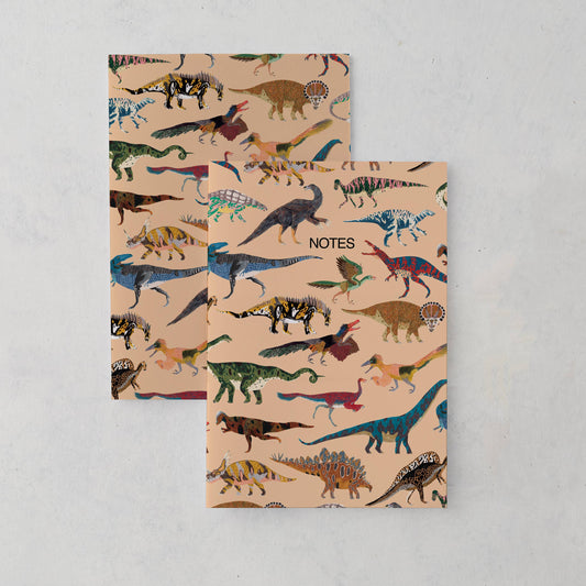 A5 dinosaur notebook featuring 18 hand-illustrated dinosaurs by James Barker on a matte finish cover; plain inside, recycled UK paper, kraft belly band.