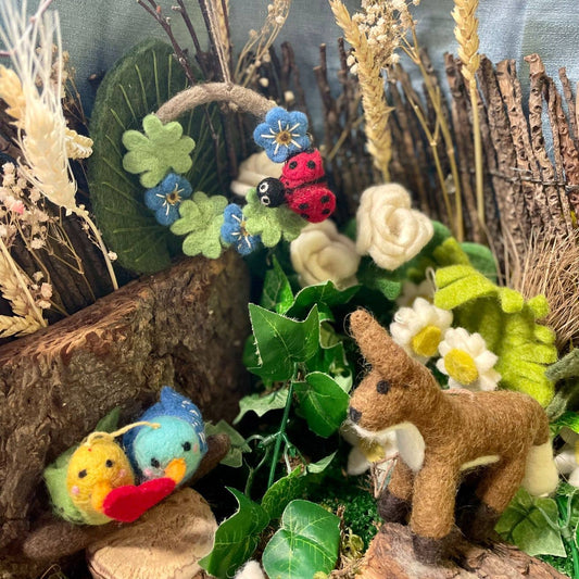 Felt ladybird mini wreath hanging, showcasing fair trade craftsmanship