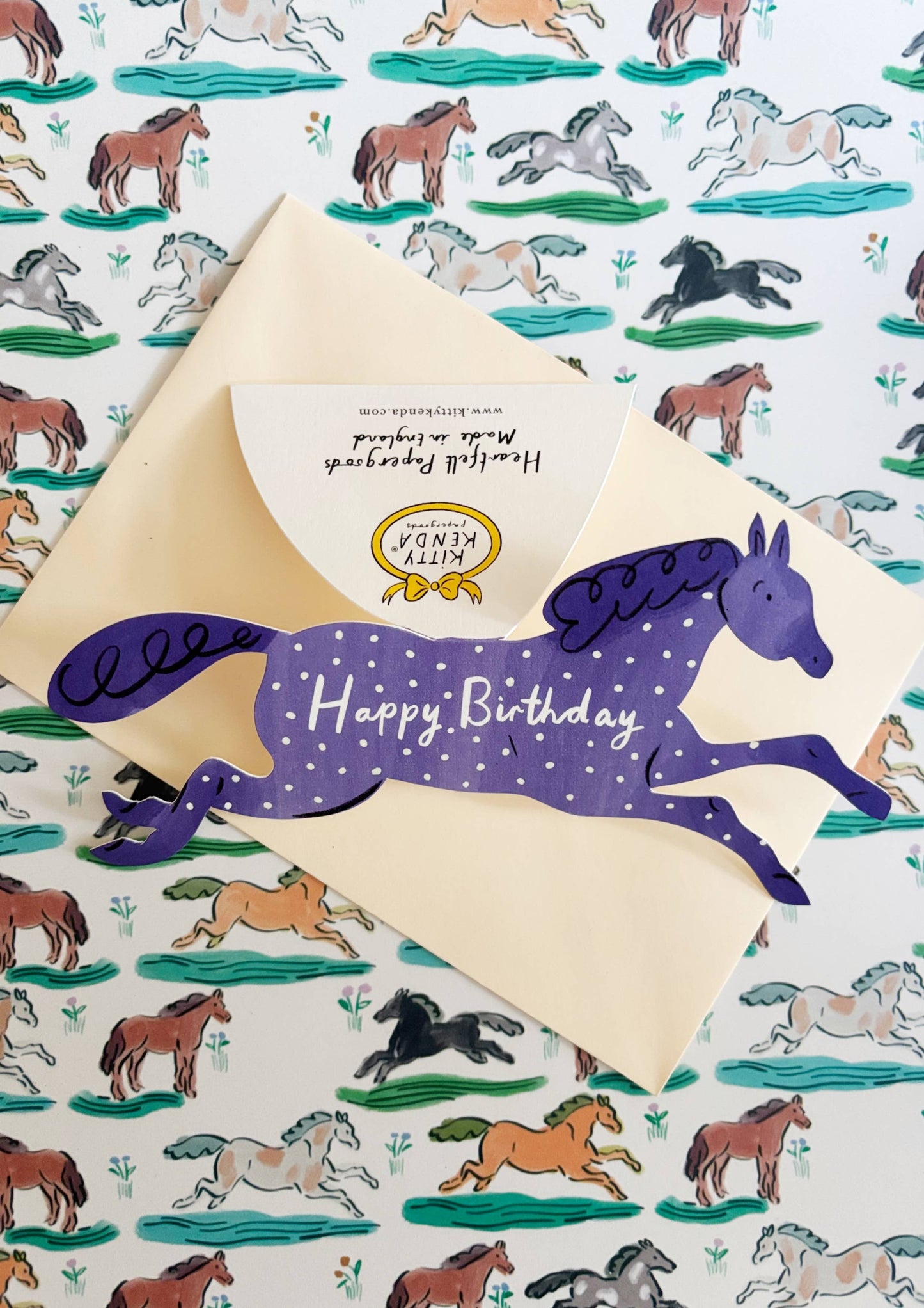 Hand-drawn blue horse shaped card with ivory envelope