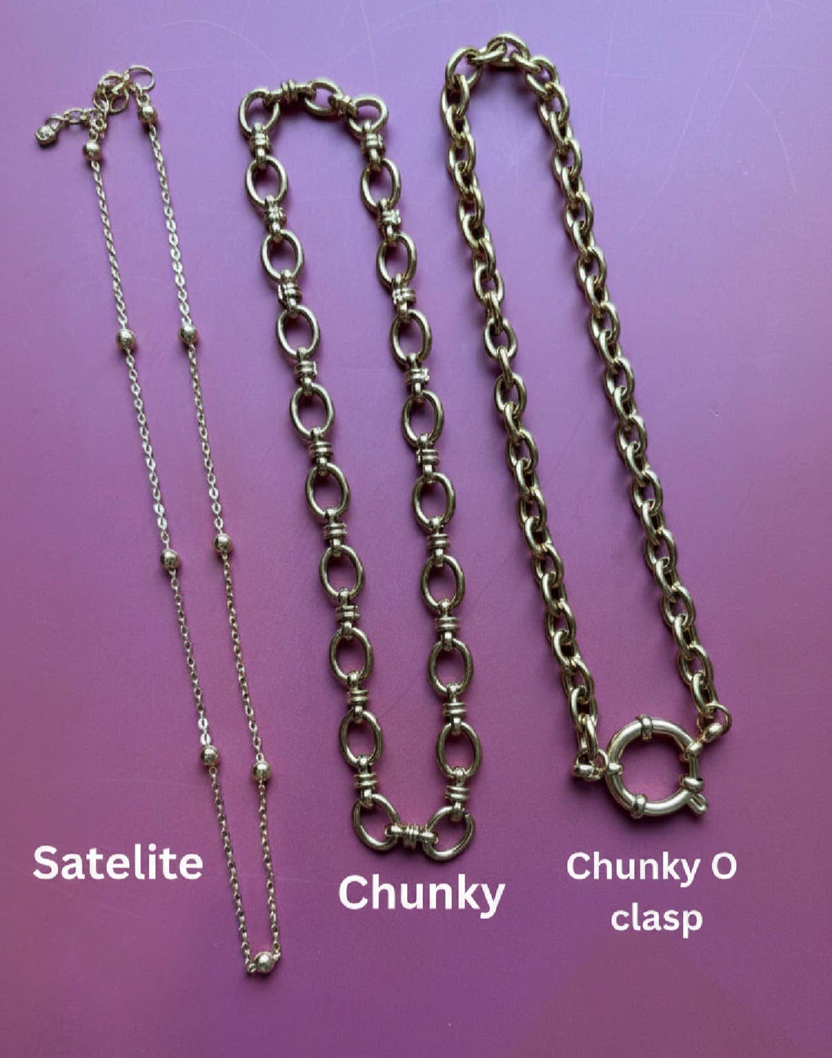 Close up of pink tarot card charm on a chunky gold chain